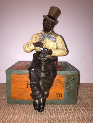 Antique Humidor/tobacco Holder Of A Black Man Sitting On A Cigar Box.