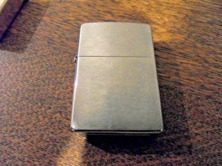 three zippo lighters plus one other cosmic.  vintage solid brass etc 3