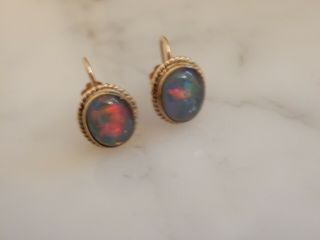 A Stunning 9 Ct Gold Antique Oval 6.  00 Carat Black Opal Earrings