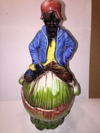 Antique Porcelain Humidor Of A Black Man Sitting On A Large Watermelon.