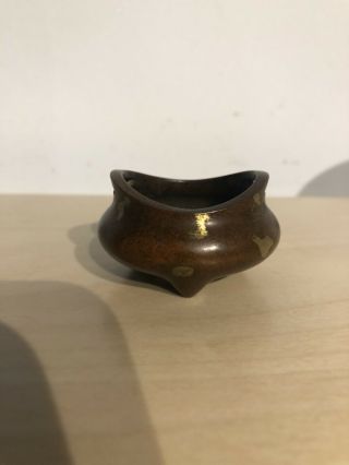 A Chinese Bronze Gold Splash Tripod Censer
