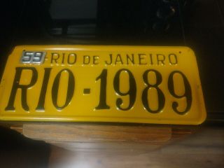 A 1989 Rio De Janeiro Brazil Orange And Black License Plate With 59 Steel Tag.