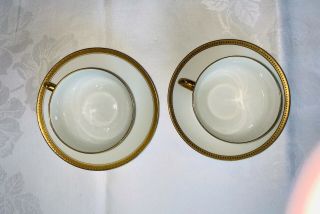 Two Vintage White Porcelain Tea Cups & Saucers With Embossed Gold Bands