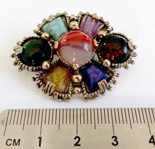 A Vintage 1950s Gold Tone Miracle Design Brooch With Glass Stones