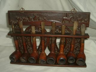 A Vintage Carved Wood Pipe Rack With 8 Various Old Pipes.