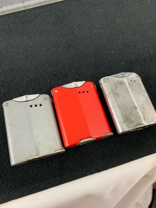 3 Vintage Warner 130 Pocket Lighters - Red,  Silver & Grey