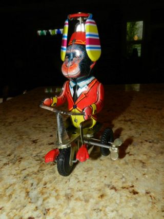 Vintage Tin Litho Wind Up Monkey,  W/helicopter Hat On Bicycle Made In China,