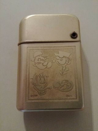 Vintage Storm Master Cigarette Lighter With Engraved Cartoon Character Faces