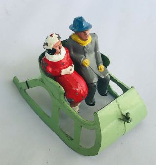 Vintage Couple Sleigh Ride Man Woman Christmas Decor Snow Tin Metal Green Sled