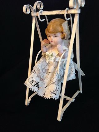 Antique German Miniature Bisque Doll Sitting On A Swing