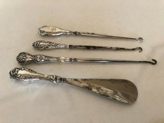 3 Silver Handled Boot Pulls And A Silver Handled Shoe Horn