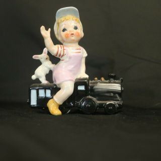 Vintage Ceramic China Figurine Boy Sitting On A Toy Train With A Bunny