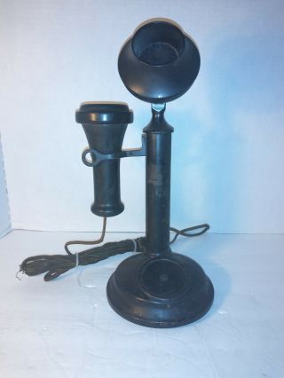 Antique candlestick phone and cast iron cookbook holder 3