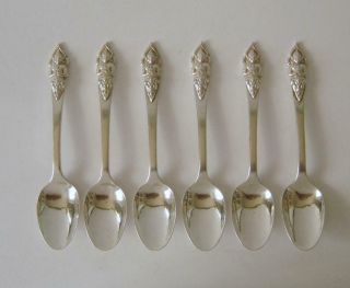 A Set Of Six Ornately Embossed Sterling Silver Demitasse Coffee Spoons