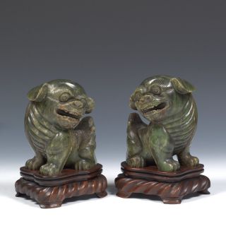 A Pair Antique Chinese Carved Green Jade Foo Dogs With Craved Rosewood Stands.