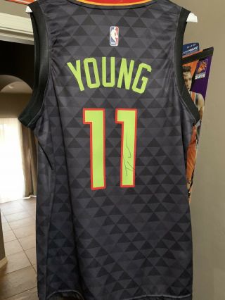 Trae Young Autographed Black Atlanta Hawks Jersey With Photo Proof