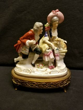 Vtg Porcelain Figurine Man & Woman Sitting On Bench W/small Lamb & Metal Stand