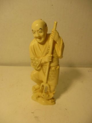 Chinese Hand Carved Ivory Colored Resin Figure Of Fisherman Spearing Fish