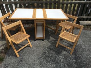 Hideaway Table And 4 Chair Set On Wheels 34”l X 63 " W X 29”h Wood Wicker Laminat