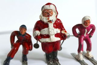 Vintage Santa On Skis,  2 Others - Barclay - With Poles - Metal - Christmas