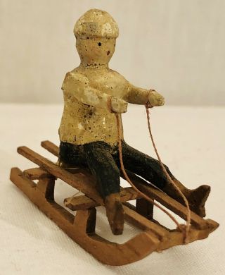 Antique German Miniature Erzgebirge Carved Putz Boy On Sled Christmas Ornament