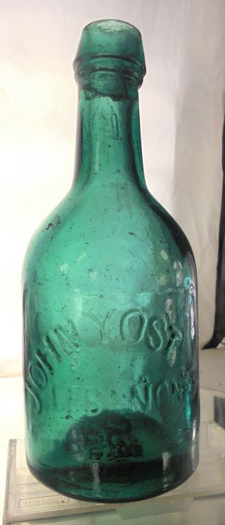 John Yost Jr.  Lebanon Pennsylvania Antique Squat Soda Bottle.  Teal.  Pontil.