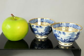 A Chinese Qianlong Period (1735 - 1796) Blue & White Gilt Decorated Cups