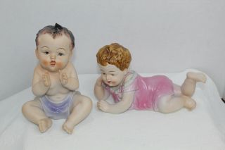 Pair Vintage Bisque Porcelain Piano Baby Figurines Babies Seated And Laying