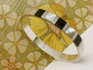 A Vintage Hallmarked Sterling Silver Mother Of Pearl & Onyx Bangle 17.  8gms.