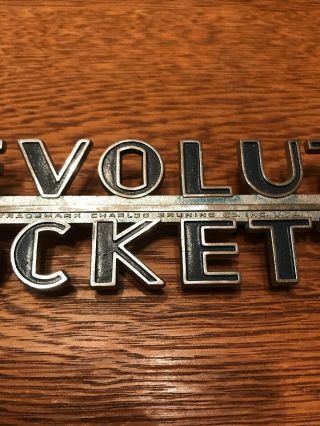 Vintage Revolute Rockette Metal Car Badge Charles Bruning Co. 2
