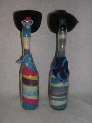 (2) Colored Sand Art Glass Bottles Dressed As Cowboys Mt.  Rushmore