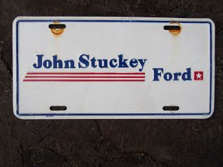 Vintage John Stuckey Ford Dealership Embossed Metal Dealer License Plate