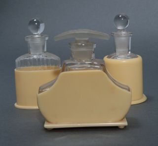 Three 1930’s French Ivory Art Deco Perfume Bottles And Celluloid Bottle Holders